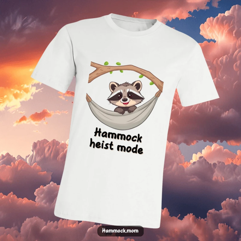 Funny raccoon peeking playfully over a hammock with a curious grin on a t-shirt, capturing mischievous delight.